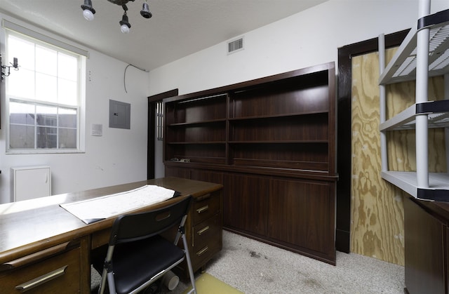 office space with light carpet, a textured ceiling, and electric panel