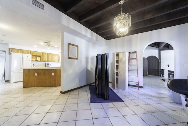 interior space with beamed ceiling, light tile patterned flooring, a textured ceiling, and a notable chandelier