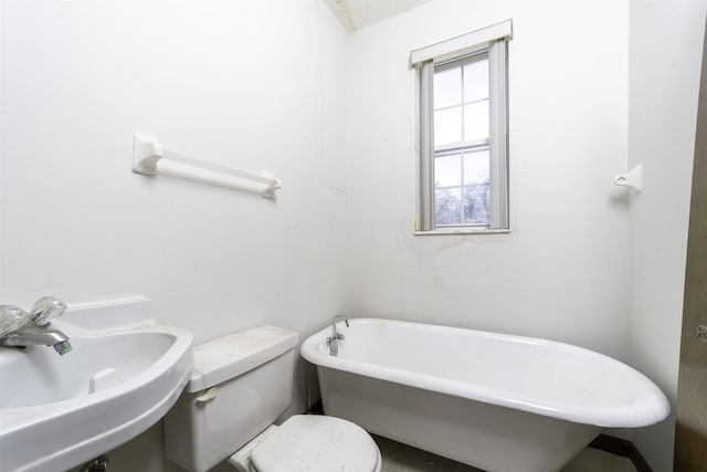 bathroom featuring toilet, sink, and a bath