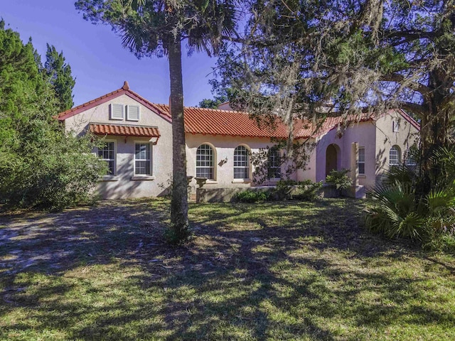 mediterranean / spanish house with a front yard