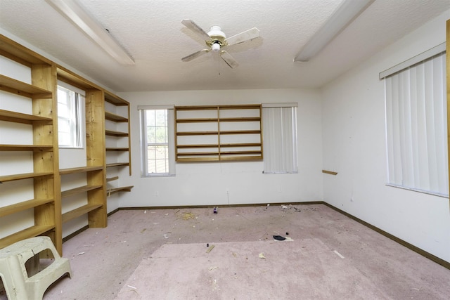 unfurnished room with heating unit, ceiling fan, and a textured ceiling