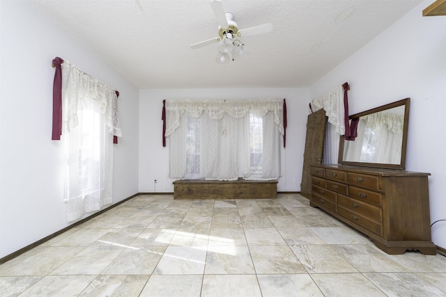 spare room featuring a textured ceiling and ceiling fan