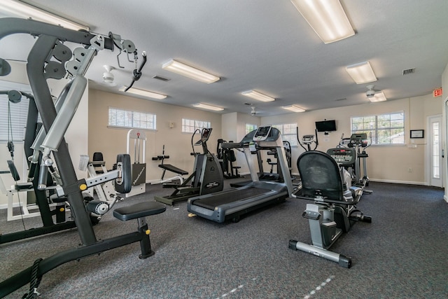 gym with a textured ceiling