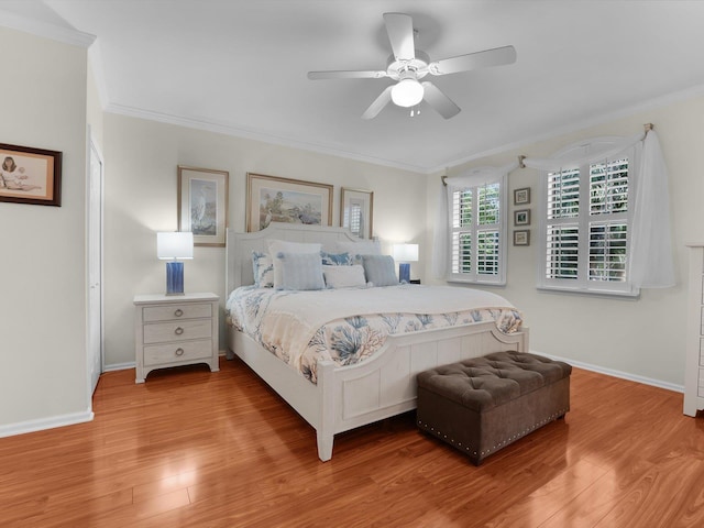 bedroom featuring crown molding, baseboards, and wood finished floors