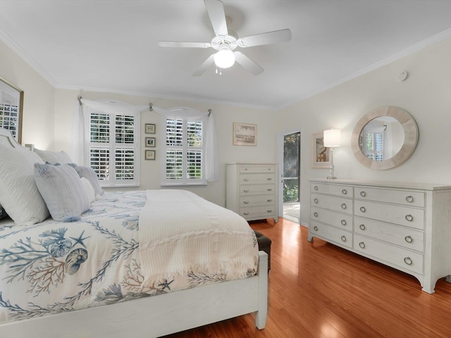 bedroom with ceiling fan, ornamental molding, and wood finished floors