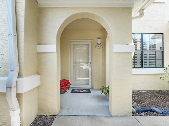 doorway to property with stucco siding