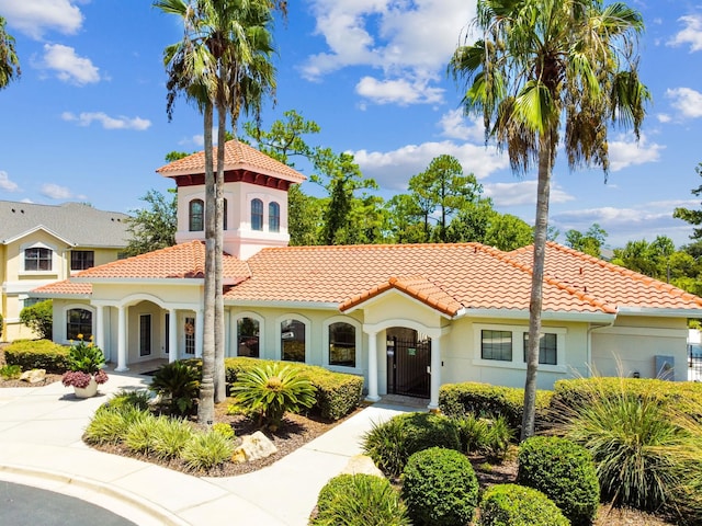 mediterranean / spanish-style home featuring a tile roof and stucco siding