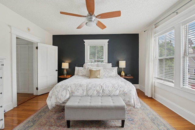 127 M L King Ave, Saint Augustine, FL 32084 - bedroom featuring multiple windows, wood finished floors, a textured ceiling, and a ceiling fan