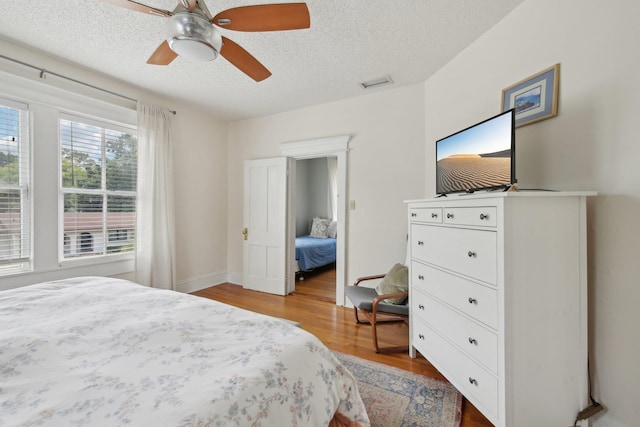 127 M L King Ave, Saint Augustine, FL 32084 - bedroom featuring wood finished floors, a textured ceiling, and ceiling fan