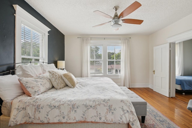 127 M L King Ave, Saint Augustine, FL 32084 - bedroom featuring wood finished floors, a textured ceiling, ceiling fan, and baseboards