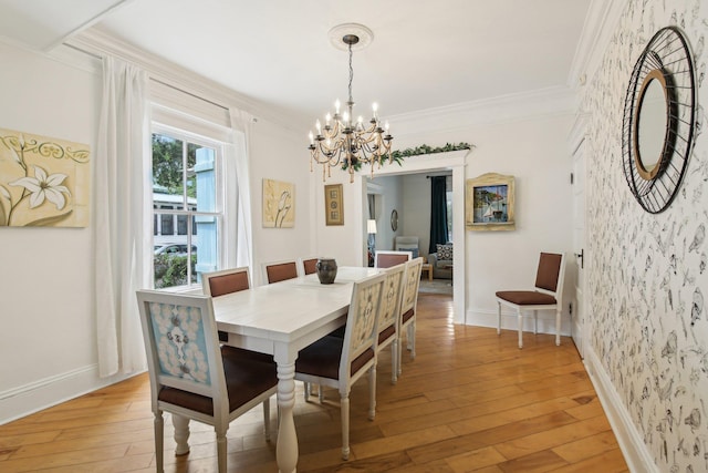 127 M L King Ave, Saint Augustine, FL 32084 - dining space with a chandelier, wallpapered walls, crown molding, light wood-style floors, and baseboards