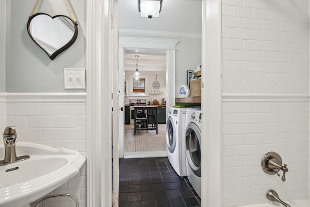 127 M L King Ave, Saint Augustine, FL 32084 - full bathroom featuring independent washer and dryer, crown molding, tile walls, a sink, and shower / washtub combination