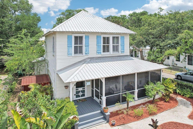 127 M L King Ave, Saint Augustine, FL 32084 - view of front of house with metal roof, a sunroom, and a standing seam roof