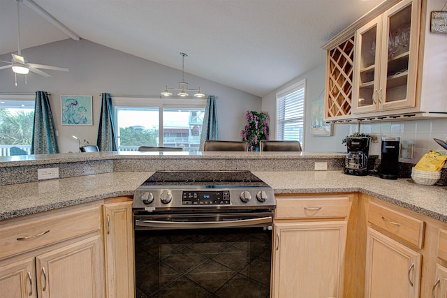 kitchen featuring light brown cabinets, vaulted ceiling, ceiling fan, and electric stove