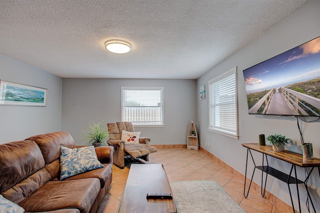 living room featuring a textured ceiling and light tile patterned flooring