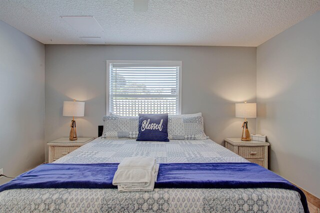 bedroom featuring hardwood / wood-style floors and a textured ceiling