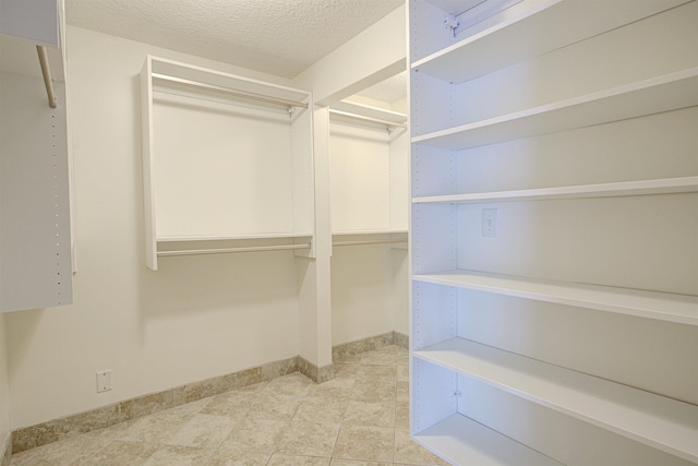 walk in closet featuring light tile patterned floors