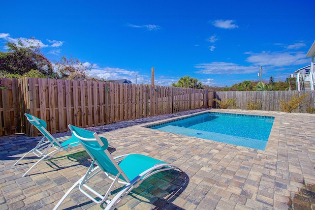 view of swimming pool featuring a patio area