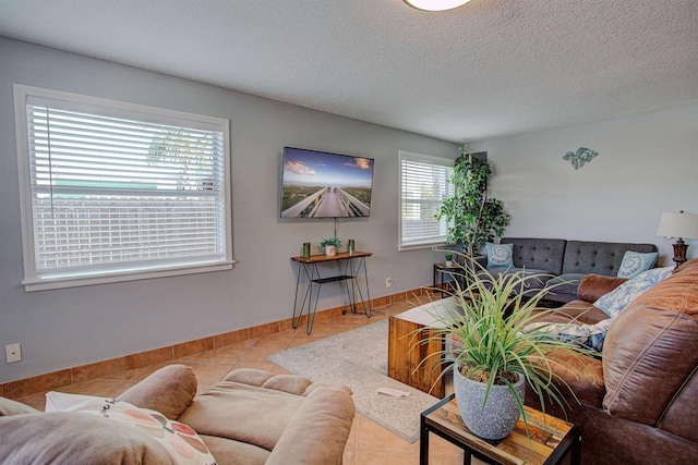 tiled living room featuring a wealth of natural light and a textured ceiling