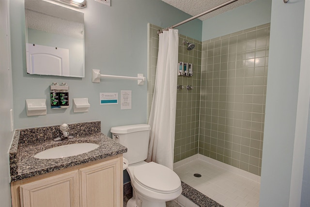 bathroom with a shower with curtain, vanity, a textured ceiling, and toilet