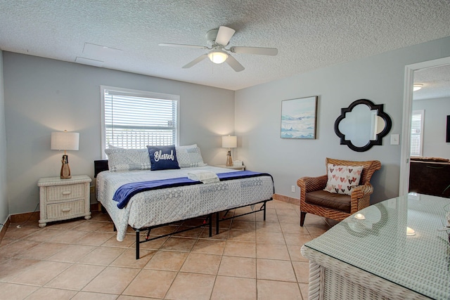 tiled bedroom featuring ceiling fan and a textured ceiling