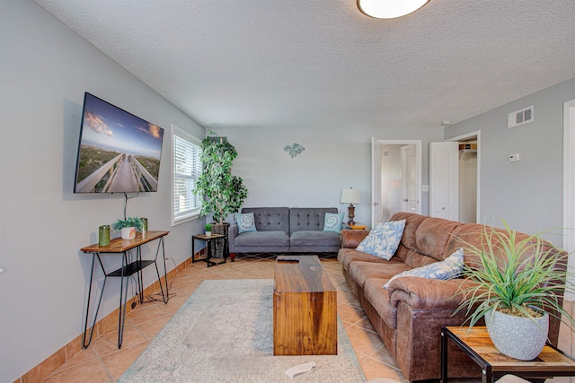 living room with light tile patterned floors and a textured ceiling