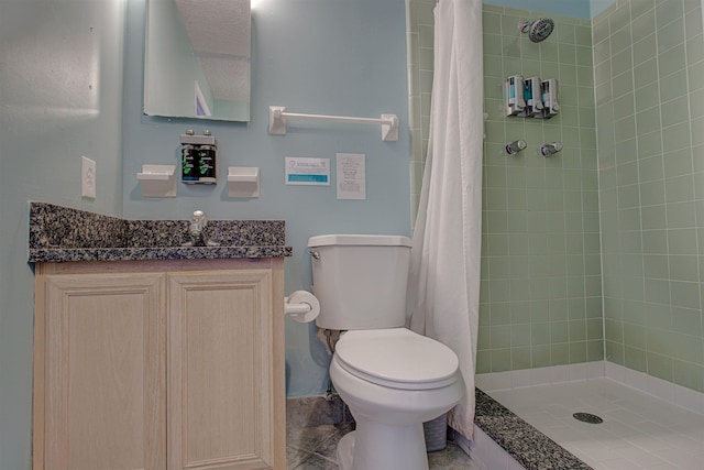 bathroom featuring a textured ceiling, vanity, toilet, and walk in shower