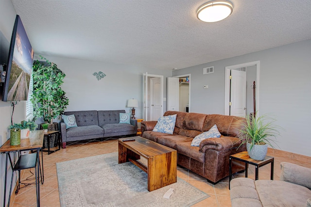 living room with light tile patterned floors and a textured ceiling