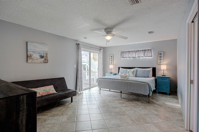 tiled bedroom featuring ceiling fan, a textured ceiling, and access to outside