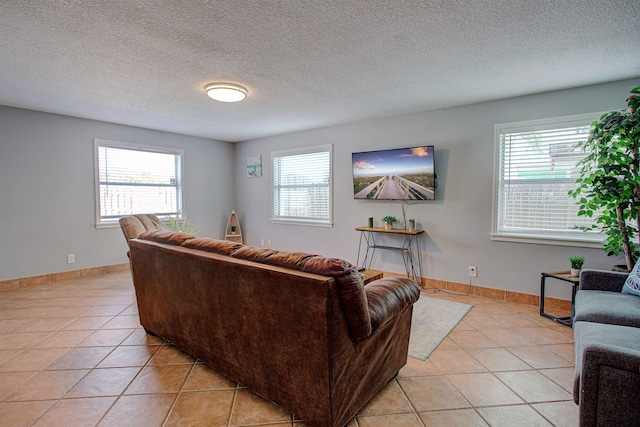 tiled living room with plenty of natural light and a textured ceiling