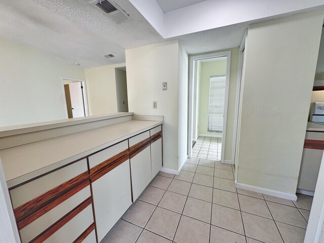 221 Mayan Ter, Saint Augustine, FL 32080 - corridor featuring light tile patterned floors and a textured ceiling