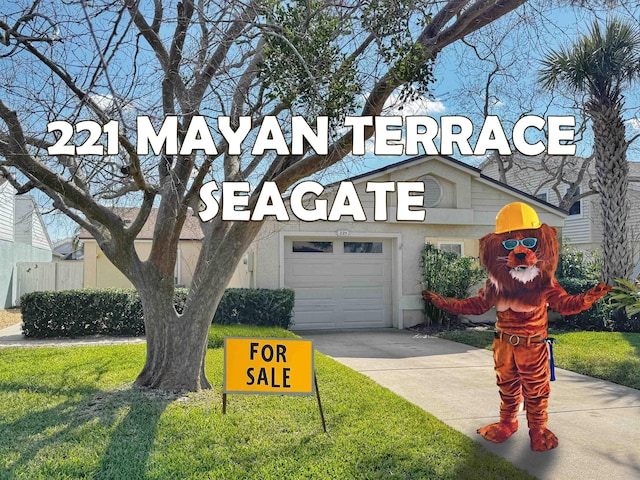 221 Mayan Ter, Saint Augustine, FL 32080 - view of front of property with a garage, driveway, stucco siding, and a front lawn