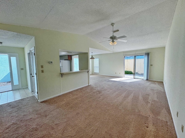 221 Mayan Ter, Saint Augustine, FL 32080 - unfurnished living room featuring carpet flooring, a ceiling fan, lofted ceiling, and a textured ceiling
