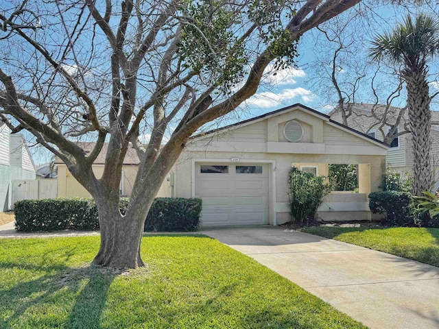221 Mayan Ter, Saint Augustine, FL 32080 - view of front facade featuring stucco siding, an attached garage, a front yard, and concrete driveway