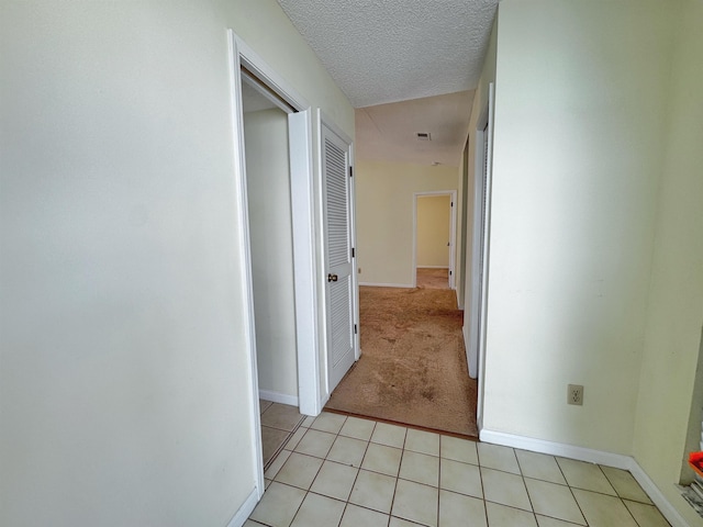 221 Mayan Ter, Saint Augustine, FL 32080 - corridor with light tile patterned flooring, light carpet, and a textured ceiling