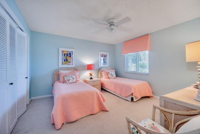 6170 A1A S Unit 101, Saint Augustine, FL 32080 - bedroom featuring carpet flooring, a closet, a textured ceiling, baseboards, and a ceiling fan