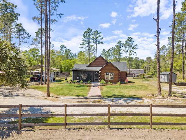 10635 Beckenger Ave, Hastings, FL 32145 - view of front of property featuring an outbuilding, a fenced front yard, a front lawn, and a storage shed