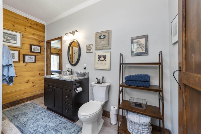 10635 Beckenger Ave, Hastings, FL 32145 - bathroom featuring crown molding, toilet, vanity, wood walls, and baseboards