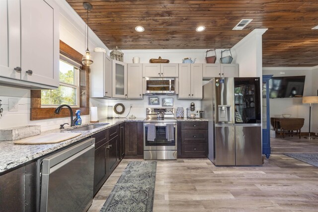 10635 Beckenger Ave, Hastings, FL 32145 - kitchen with light wood-type flooring, wood ceiling, a sink, light stone counters, and appliances with stainless steel finishes