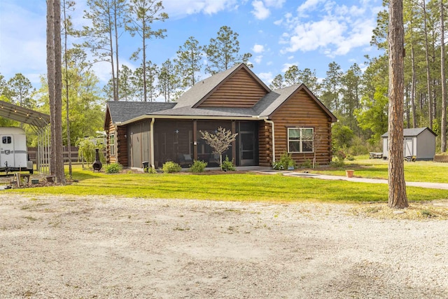 10635 Beckenger Ave, Hastings, FL 32145 - view of front of home with a front lawn, a shingled roof, a sunroom, and log exterior
