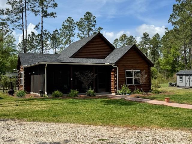 10635 Beckenger Ave, Hastings, FL 32145 - log home featuring log siding and a front yard