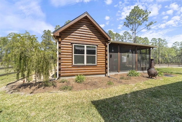 10635 Beckenger Ave, Hastings, FL 32145 - back of property with log siding, a sunroom, fence, and a yard