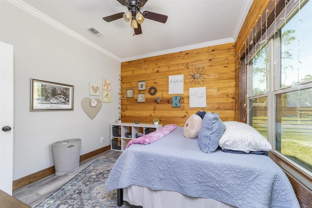10635 Beckenger Ave, Hastings, FL 32145 - bedroom with a textured ceiling, visible vents, baseboards, ornamental molding, and wood finished floors