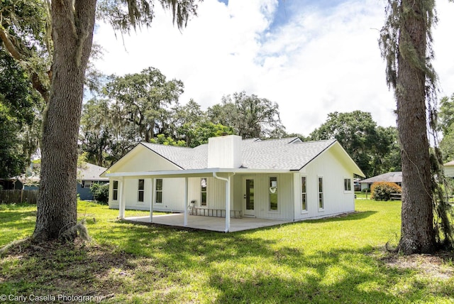 552 Fox Hollow Ln, Saint Augustine, FL 32086 - back of property with roof with shingles, a patio area, a chimney, and a lawn