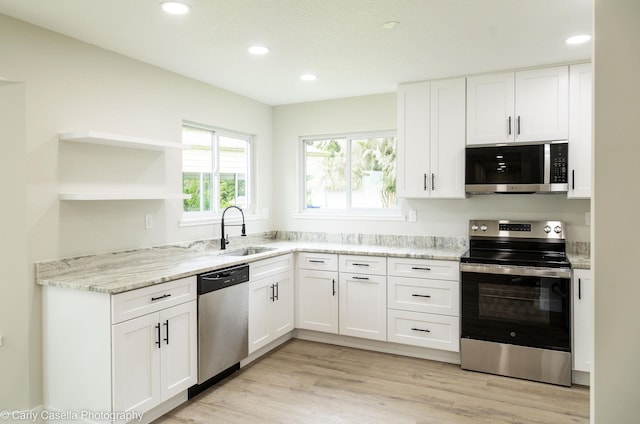 552 Fox Hollow Ln, Saint Augustine, FL 32086 - kitchen with appliances with stainless steel finishes, white cabinets, recessed lighting, and light wood-type flooring