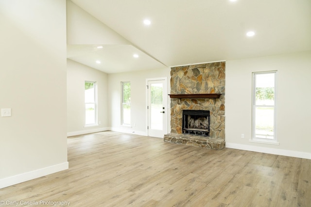 552 Fox Hollow Ln, Saint Augustine, FL 32086 - unfurnished living room with plenty of natural light, a stone fireplace, wood finished floors, recessed lighting, and lofted ceiling