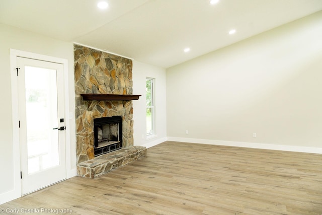 552 Fox Hollow Ln, Saint Augustine, FL 32086 - unfurnished living room with light wood-style flooring, a stone fireplace, recessed lighting, and lofted ceiling