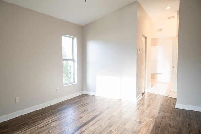 unfurnished room with wood-type flooring