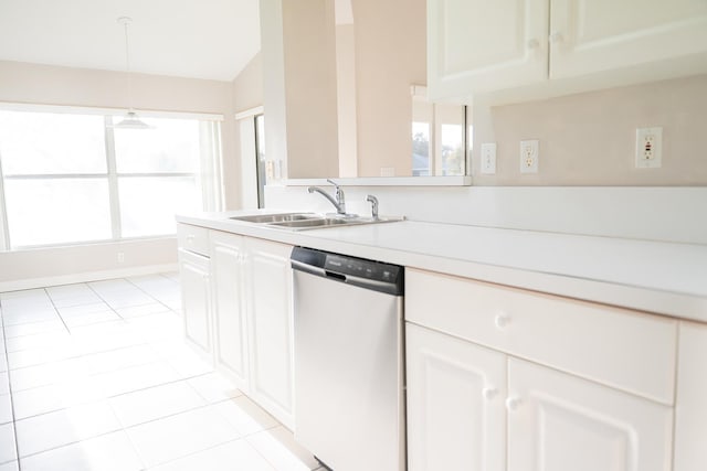 kitchen featuring decorative light fixtures, white cabinetry, sink, stainless steel dishwasher, and light tile patterned floors