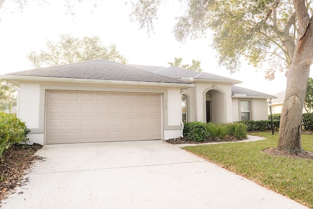 view of front of home with a garage and a front yard